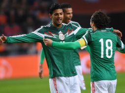 Vela anotó dos de los tres goles que dieron el triunfo al Tri frente a la Naranja Mecánica. AFP / E. Dunand