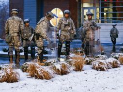 Soldados vigilan afuera de un cuartel de la policía en Ferguson luego de que manifestantes regresaran a las calles. EFE / T. Mauri