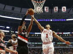 Derrick Rose (d) de Toros ante LaMarcus Aldridge (c) de Blazers durante el juego de ayer en Chicago. EFE / K. Krzaczynski