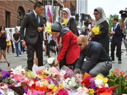 La calle peatonal de Martin Place, donde sucedió el ataque, se llena de ofrendas florales. AFP / W. West