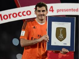 Casillas muestra el sello que el Real Madrid portará oficialmente durante todo el 2015 que lo acredita como Campeón del Mundo en 2014. AFP / J. Soriano