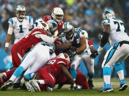 Jonathan Stewart (28), de los Panteras de Carolina, pelea el balón contra los Cardenales de Arizona. AFP / S. Lecka