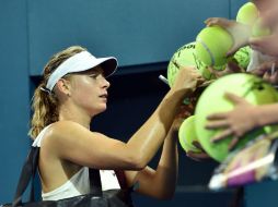 Maria Sharapova da autógrafos a los aficionados después de su partido semifinal. AFP / S. Khan