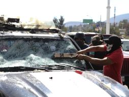 Trabajadores de la CETEG causan destrozos a una patrulla estacionada. SUN / C. Rogel