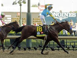 El jinete mexicano, Víctor Espinoza levanta el brazo al cruzar la meta en el Derby de Kentucky. AP / M.Gash