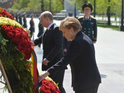 Merkel depositó una ofrenda floral en la tumba del Soldado Desconocido junto al Kremlin, acompañada por Putin. EFE / Host Photo Agency