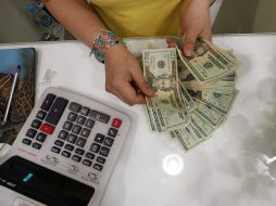 El dólar se ofrece hasta en 15.53 pesos y se adquiere en un mínimo de 14.35 pesos, en la terminal aérea de la capital mexicana. EL INFORMADOR / ARCHIVO