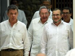 Juan Manuel Santos (i) y el máximo líder de las FARC, Timoleón Jiménez (d), en la firma del acuerdo en La Habana. AFP / L. Acosta