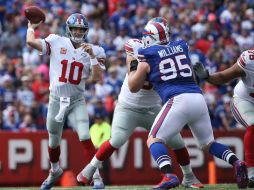 Eli Manning conectó 20 de sus 35 pases para 212 yardas. AFP / T. Szczerbowski