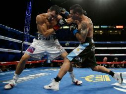 NUEVO CAMPEÓN. Viktor Postol (izq.) golpea de zurda la cara del argentino Lucas Matthyse. AFP / J. Gross