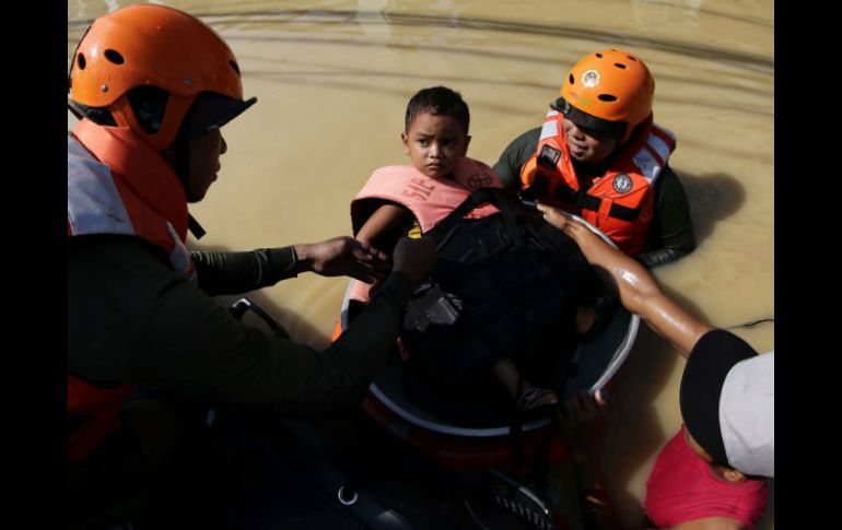 Soldados filipinos rescatan a un niño tras las inundaciones que causó 'Koppu'. EFE / F. Malasig