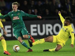 El  mexicano Jonathan dos Santos se barre con fuerza tras el balón que conduce Philipp Schobesberger, del Rapid de Viena. AP / A. Saiz