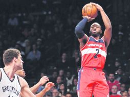 John Wall encabezó la ofensiva de los Wizards al conseguir 22 puntos en su cuenta personal durante el partido frente a los Nets. AP / K. Willens