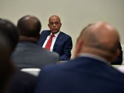 Martelly firmó un acuerdo con los titulares del Senado y la Cámara de Diputados para designar un gobierno de transición. AFP / H. Retamal