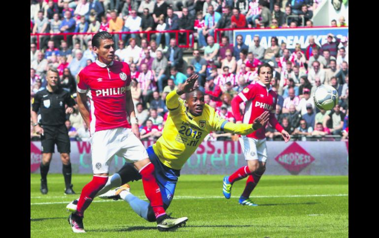 Héctor Moreno (izq) observa el balón en la victoria del PSV. Andrés Guardado (al fondo), participó durante todo el encuentro. EFE / J. Leenen