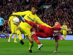 Dos Santos disputa un balón con Roberto Moreno del Liverpool. AP / J.Super