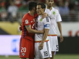 El jugador chileno Charles Aranguiz (i) anima a Andrés Guardado (d) durante un receso en el partido. EFE / D. Fernández