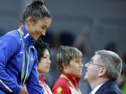 Thomas Bach saludando a una atleta. AP / S.Riedel