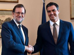 Mariano Rajoy saluda a Pedro Sánchez, líder del PSOE, en una reunión previa al inicio del debate de investidura. AFP / G. Julien