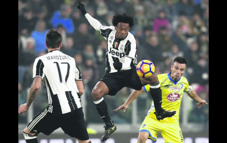 El colombiano de la Juventus, Juan Cuadrado, gana el balón por aire durante el partido contra el Pescara. AFP /