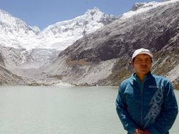 Luciano Lliuya posa frente al lago que se ha formado debido al calentamiento; teme que algún día se desborde. AFP / C. Bouroncle