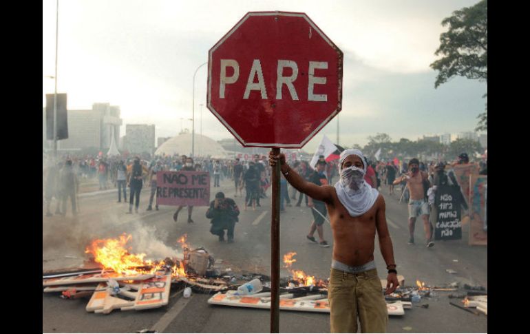 Los inconformes resistieron las cargas policiales erigiendo barricadas a lo largo de la explanada de los ministerios. EFE / J. Alves