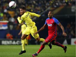 Dos Santos (I) disputa un balón con William de Amorim (D), de Steaua Bucarest. AFP / J. Jordan