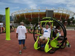 Algunas personas realizan ejercicio frente al centro de tenis de las nuevas instalaciones del Parque Olímpico Río 2016. EFE / M. Sayao