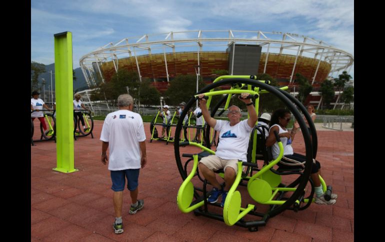 Algunas personas realizan ejercicio frente al centro de tenis de las nuevas instalaciones del Parque Olímpico Río 2016. EFE / M. Sayao