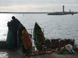 La gente deja coronas de flores y enciende velas en honor a las víctimas, entre ellas un coro militar, periodistas y una altruista. EFE / Y. Reutov