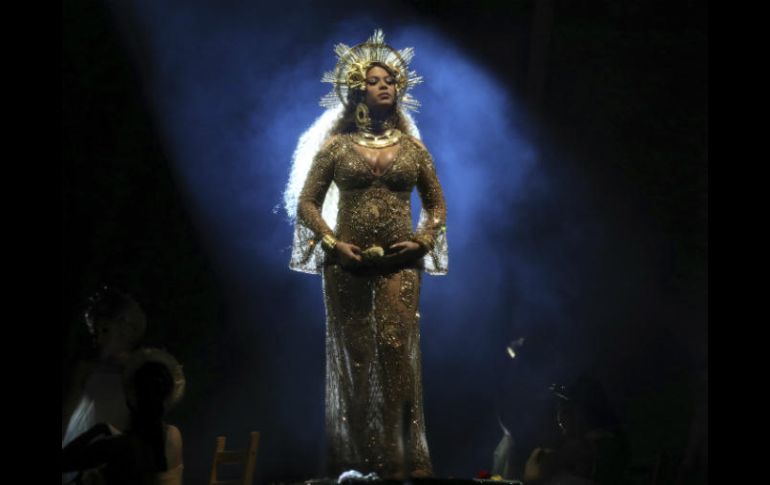 Beyoncé lució su embarazo con un vestido dorado y una corona del mismo color. AP / M. Sayles