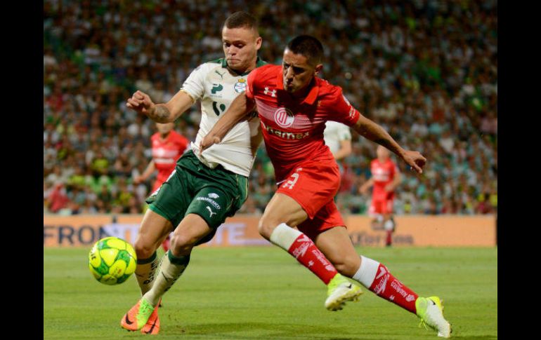 Jonathan Rodríguez y Jesús Méndez disputan el balón. AFP / O. Wong