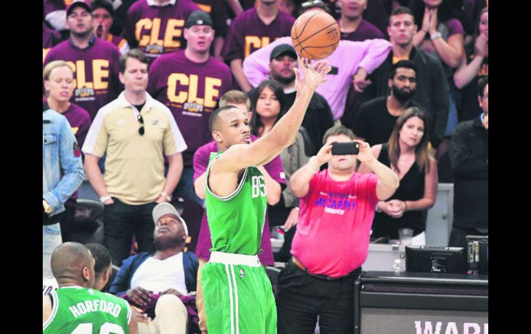 Avery Bradley (c), realiza un disparo desde el perímetro que terminó por encestarse y que le significó el primer triunfo para Celtics. AFP / J. Sabau