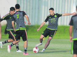 Práctica ligera. 'Chicharito' patea el balón junto a Carlos Vela e Hirving Lozano. AP /