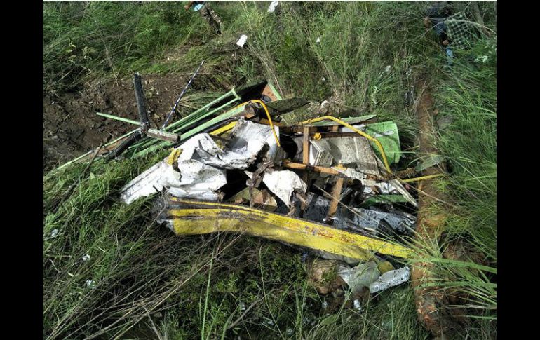 El autobús se salió de la carretera y rodó colina abajo unos 300 metros hasta estrellarse en la ribera de un río y quedar destrozado. AFP / STR