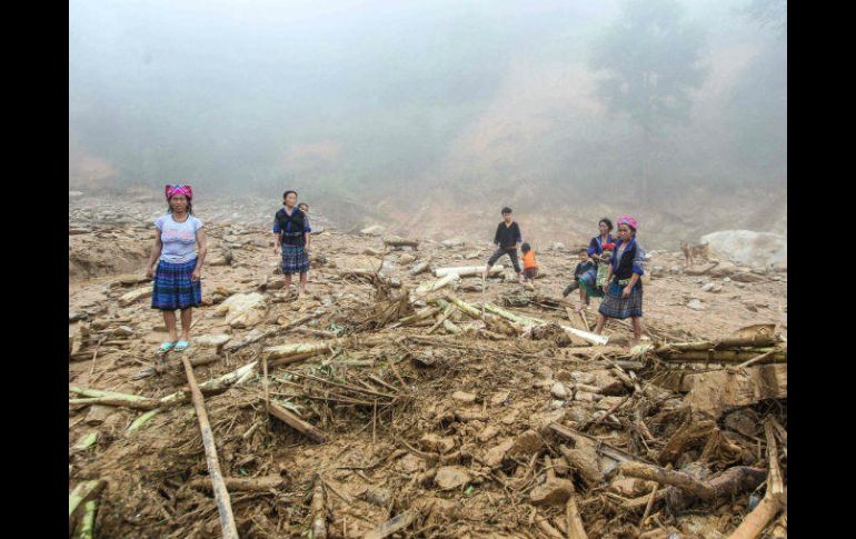 Familias vietnamitas observan a lo que quedaron reducidos sus hogares, en el distrito de Mu Cang Chai. AFP / ARCHIVO