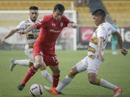 Rubens Sambueza disputa el balón con dos jugadores de Sinaloa. TWITTER / TolucaFC