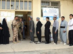 Varios ciudadanos kurdos esperan para emitir su voto en un colegio electoral de Erbil.