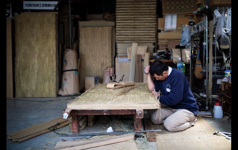 Hiroshi Yanai fabrica tatamis en su taller de Tokio, Japón. Es uno de los pocos que aún hacen los tatamis a mano, mientras la demanda decrece en el país y las máquinas chinas hacen el trabajo. AFP/B. Mehir