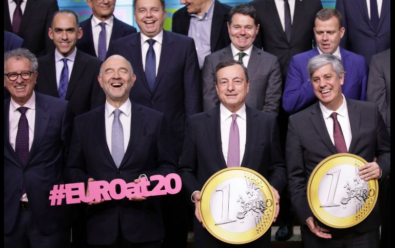 El comisario europeo de Asuntos Económicos y Financieros, Pierre Moscovici (i a d), presidente del Banco Central Europeo, Mario Draghi, y el presidente del Eurogrupo, Mário Centeno, posan en una reunión de ministros de Economía y Finanzas de la eurozona que se celebra en Bruselas. El euro cumple en enero 20 años de comenzar a circular. AP/O. Matthys