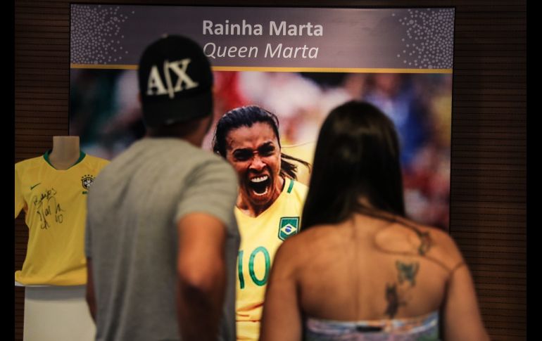 Una pareja de turistas observa una fotografía de la jugadora brasileña Marta Vieira da Silva, durante la inauguración de un área dedicada a la futbolista hoy en el museo del Estadio Mario Filho, conocido popularmente como Maracaná, en Río de Janeiro. Marta es la primera mujer en tener un reconocimiento de este nivel en el 