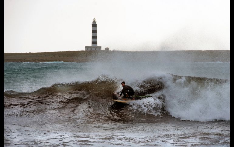 Surfistas aprovechan para practicar en la playa de Punta Prima, en la población española de Sant Lluís Menorca. EFE/D. Arquimbau