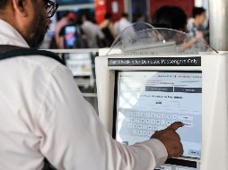 Un pasajero en el aeropuerto de Nueva Delhi trata de obtener un pase de abordar en una computadora afectada. Los aeropuertos fueron los primeros en reportar las fallas. EFE/R. Gupta