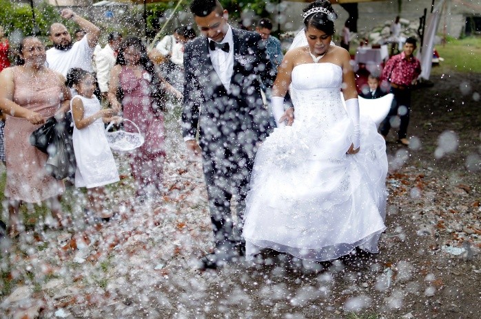 Aremy Sanchez Flores walks with her husband Jose Padilla after getting married in a empty lot in front a church that collapse after an earthquake in Atzala, Mexico, Saturday, Sept. 23, 2017. Eleven people died during a baptism last Tuesday in the Church where the couple had to get married. Flores said she was very sad but is time to move forward. (AP Photo/Natacha Pisarenko) - SATURDAY, SEPT. 23, 2017 PHOTO