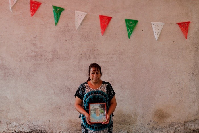 Juana Villanueva, 41 years old, holds the photo of her mother Carmela Meresis, who died in a church during the earthquake in Atzala, Mexico, Saturday, Sept. 23, 2017. Villanueva lost her two sister, a brother in law, a nephew and a nice. All of them where attending a baptism when the Church collapsed. Eleven people died inside the building. “We’ve got to have the will because God left us here, in this life, we’re alive for a reason. It’s to rise above all else and support each other. This is really hard what we’re dealing with, but if we don’t give al we’ve got and have strength and courage from where we can, who will?. If we don’t help each other spiritually and emotionally we’ll fall, and no, we have to have the will because life goes one. 