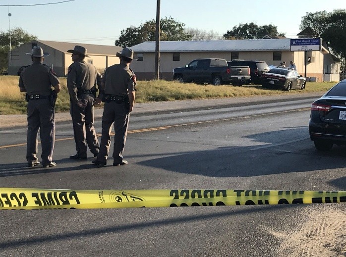 TOPSHOTS Mass Shooting at First Baptist Church in Sutherland Springs, Texas - TOPSHOT - Police block a road in Sutherland Springs, Texas, on November 5, 2017, after a mass shooting at the the First Baptist Church (rear). A gunman went into the church during Sunday morning services and shot dead some two dozen worshippers, the sheriff said, in the latest mass shooting to shock the US. 