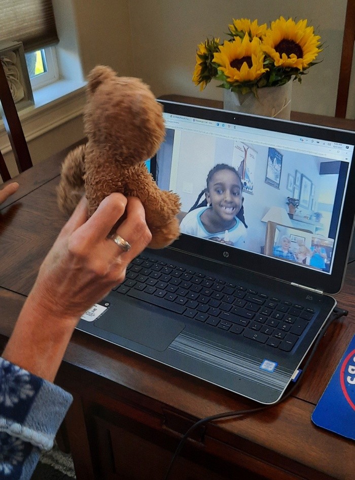 In this photo provided by Terri Hayden of Bigfork, Mont., Hayden talks online with Naomi Pascal on Oct. 2, 2021, as a friend shows Naomi the teddy bear the little girl lost in Glacier National Park, Montana, a year earlier. (Terri Hayden via AP)-AP PROVIDES ACCESS TO THIS THIRD PARTY PHOTO SOLELY TO ILLUSTRATE NEWS REPORTING OR COMMENTARY ON FACTS DEPICTED IN IMAGE; MUST BE USED WITHIN 14 DAYS FROM TRANSMISSION; NO ARCHIVING; NO LICENSING; MANDATORY CREDIT